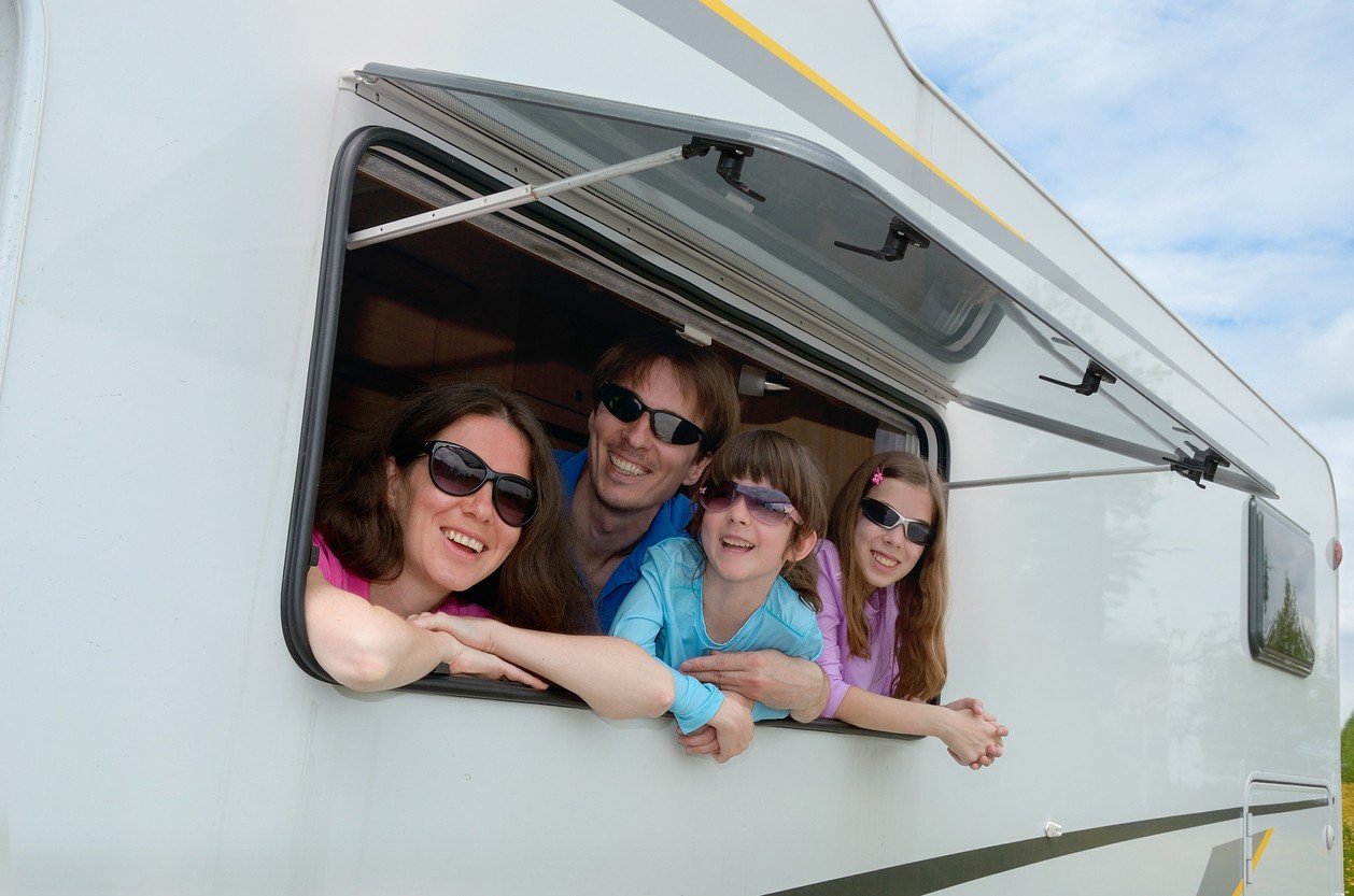 family-looking-out-the-window-of-rv